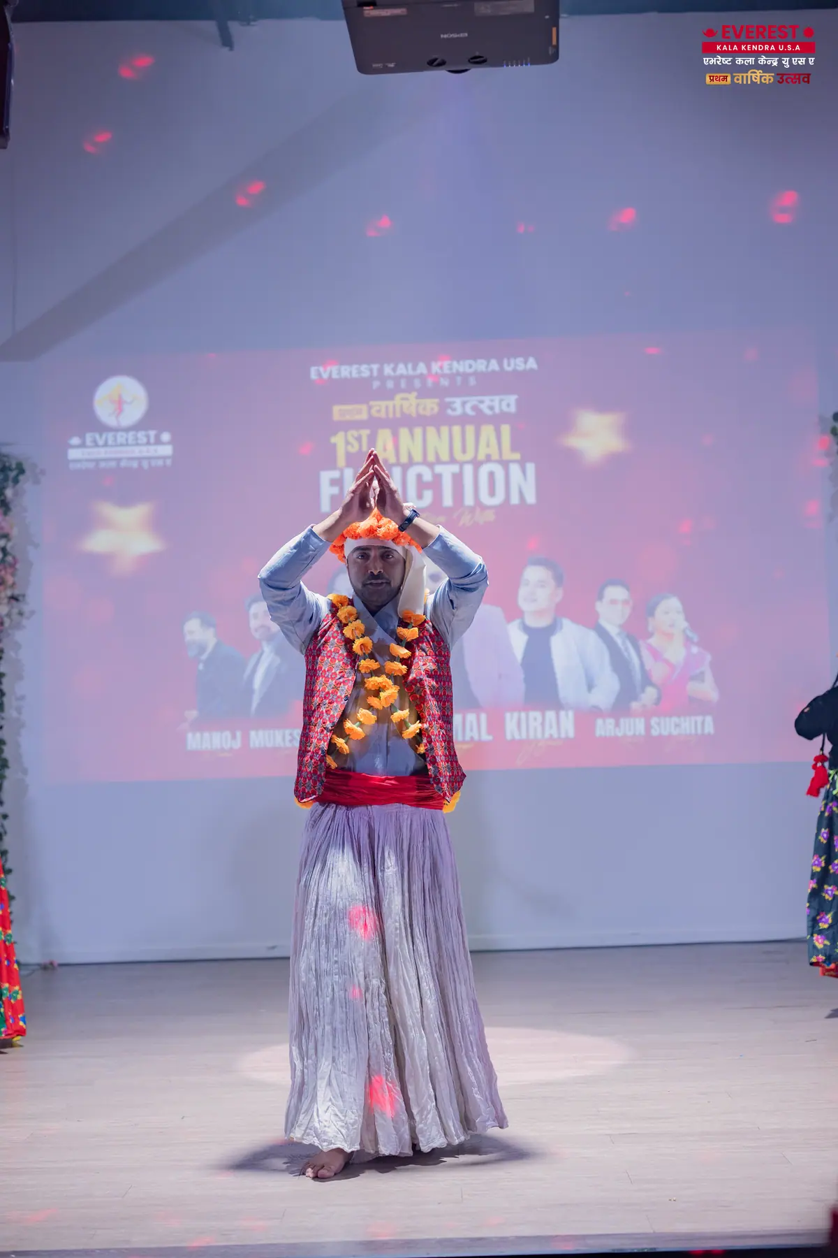 A single EKK dancer in full traditional costume performing centre stage