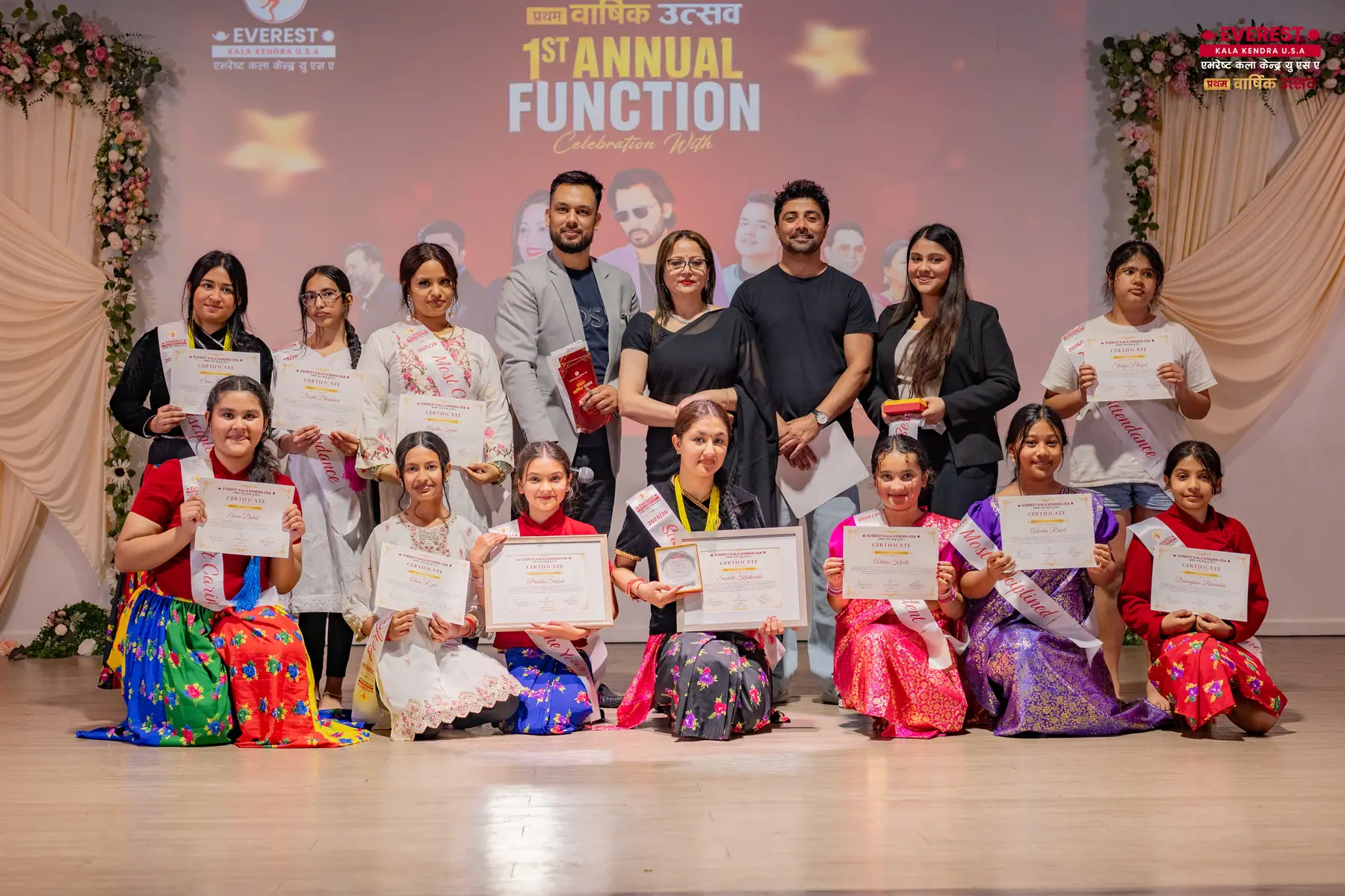 The full group of EKK students in traditional Nepali dress assembled on stage