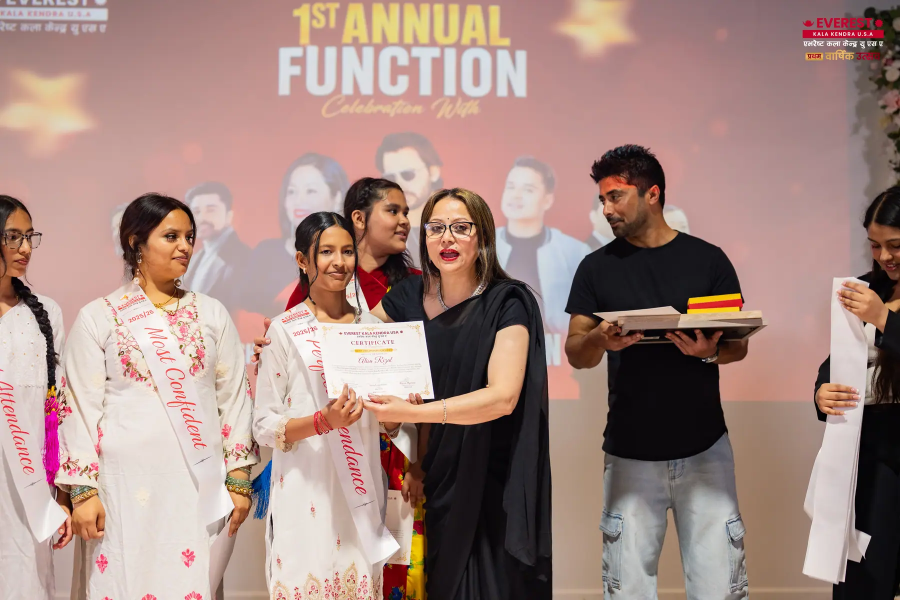 A group of EKK students and staff on stage during the certificate presentation