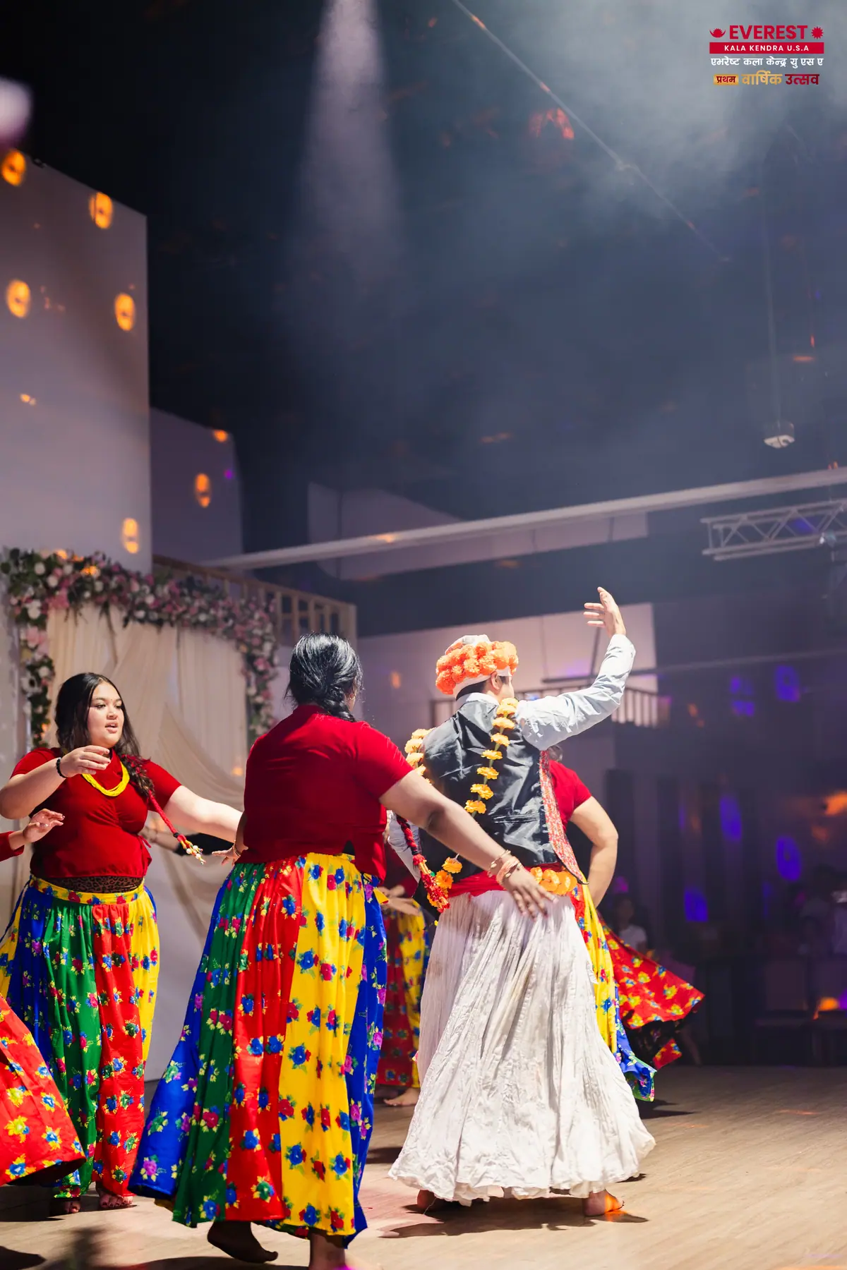EKK dancers performing together under bright white stage spotlights